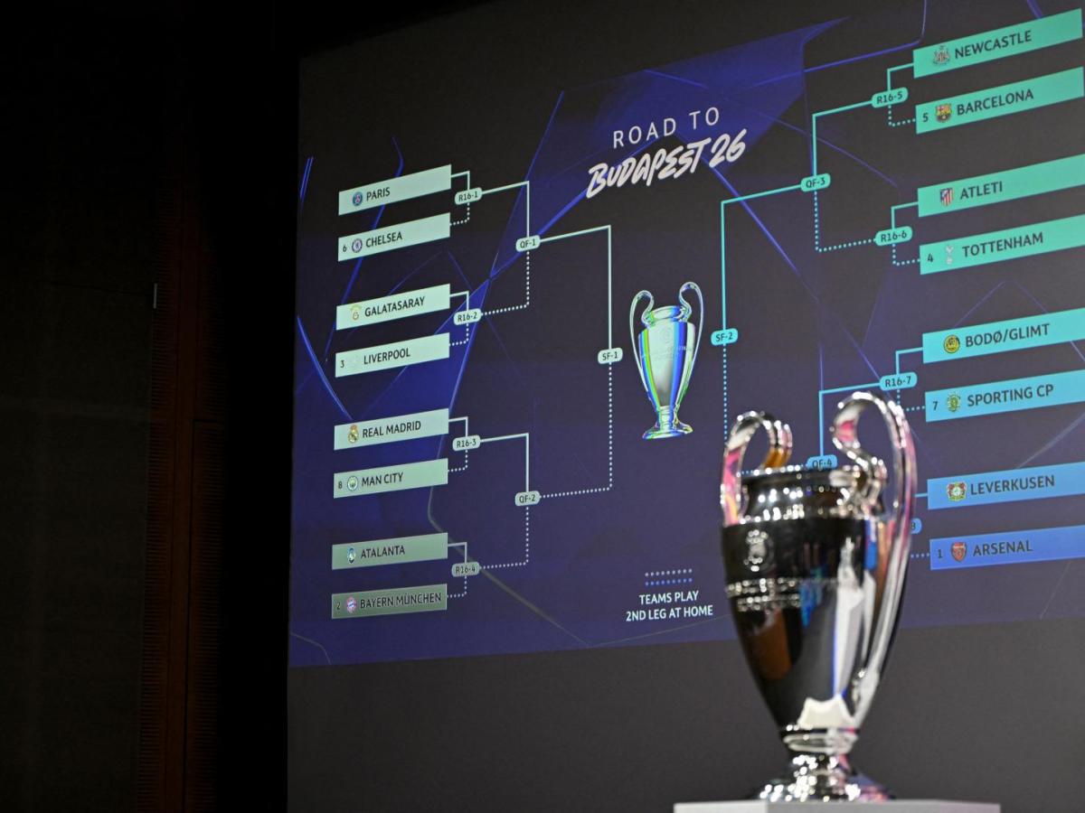 Esta fotografía muestra la Copa de la Liga de Campeones de la UEFA junto a una pantalla en la que se muestran los resultados del sorteo de los octavos de final, cuartos de final y semifinales de la Liga de Campeones de la UEFA 2025-2026 en la Casa del Fútbol Europeo en Nyon, Suiza. AFP