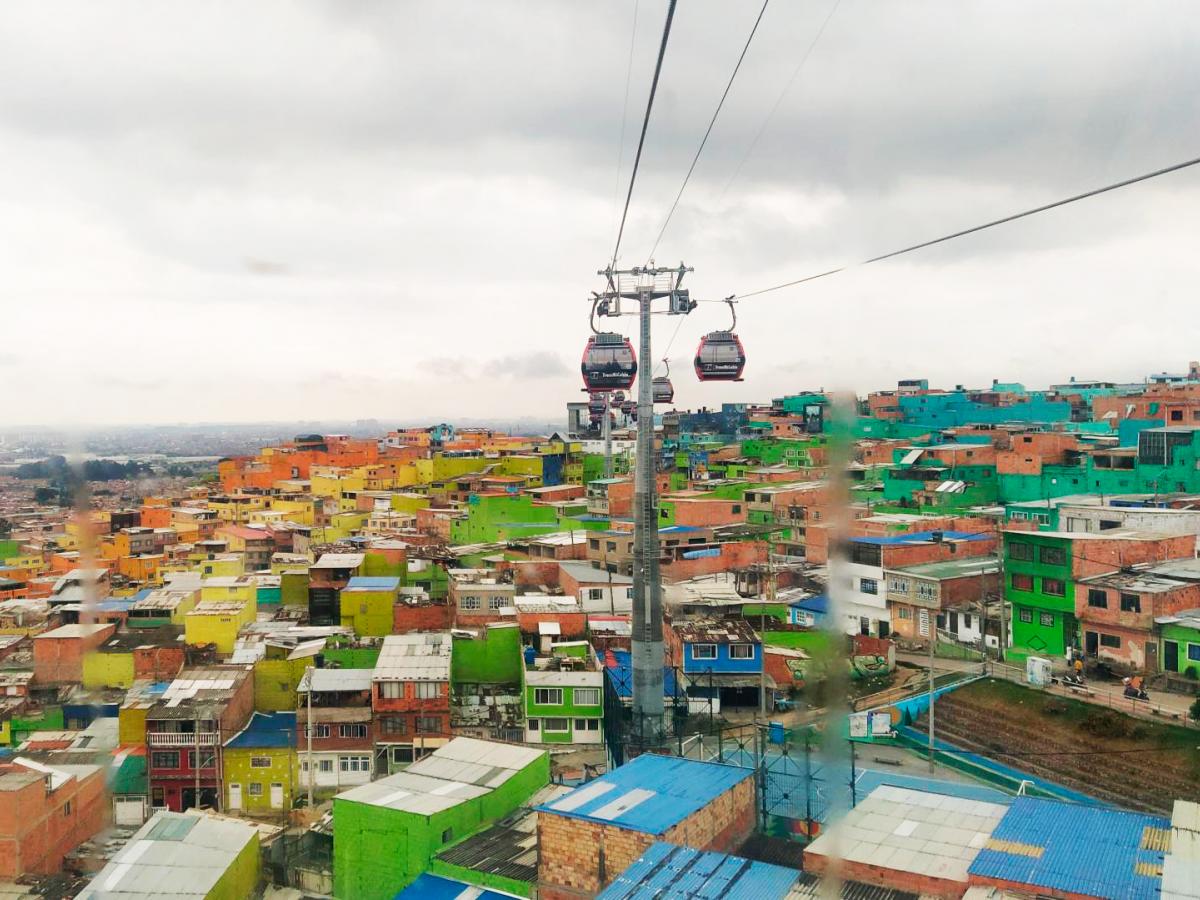 Cable cars run over a neighborhood of colorful houses in Bogotá, Colombia